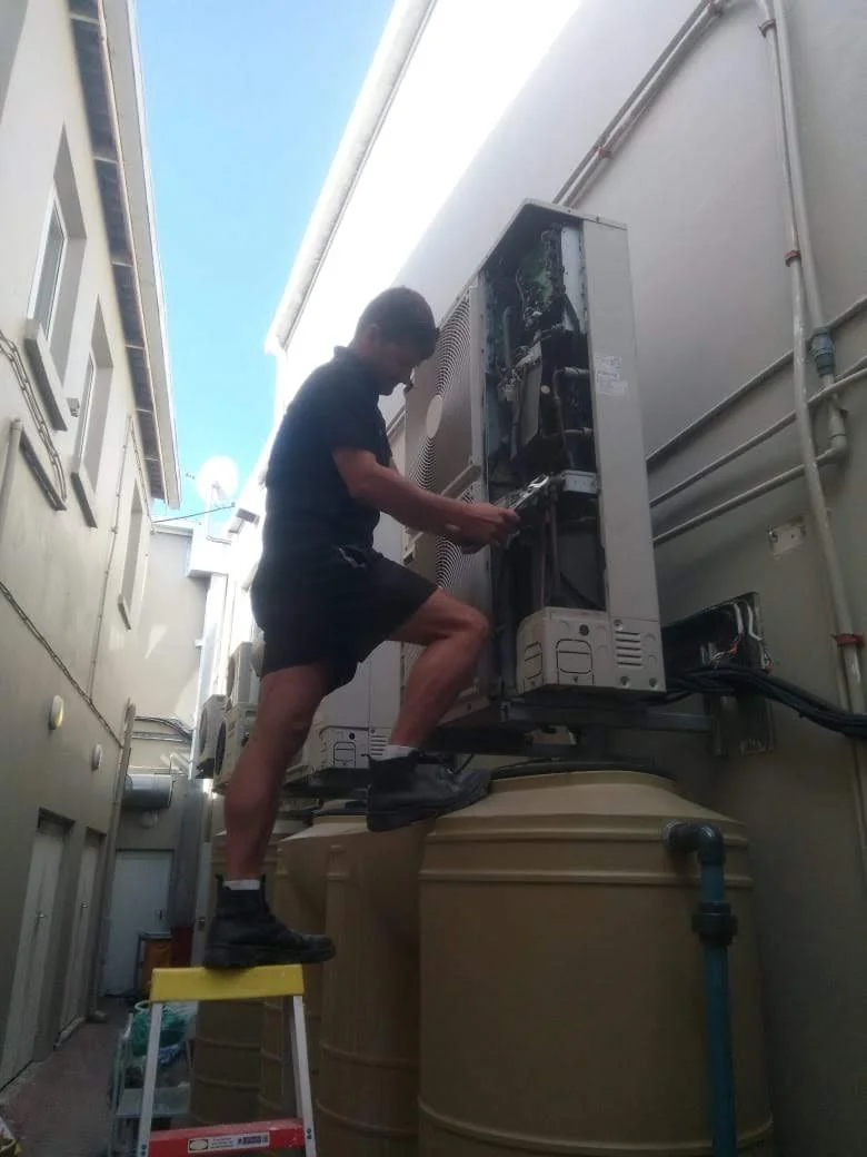 HVAC technician repairing system